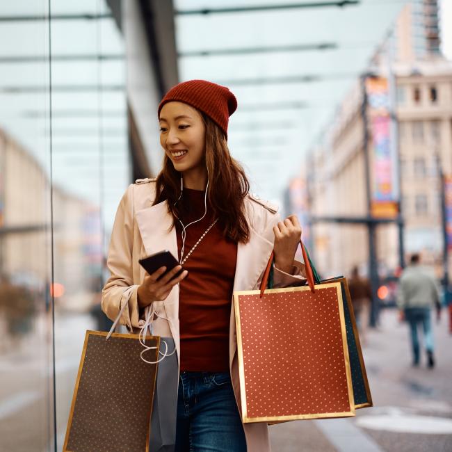 Woman shopping with a phone in her hand.